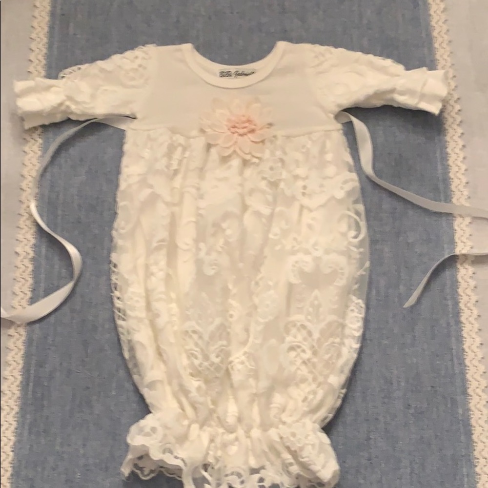 Onesie lace outfit with floral appliqué in front.